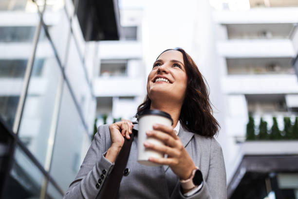 istock Woman Enjoying Coffee Outside the Office 1977126440