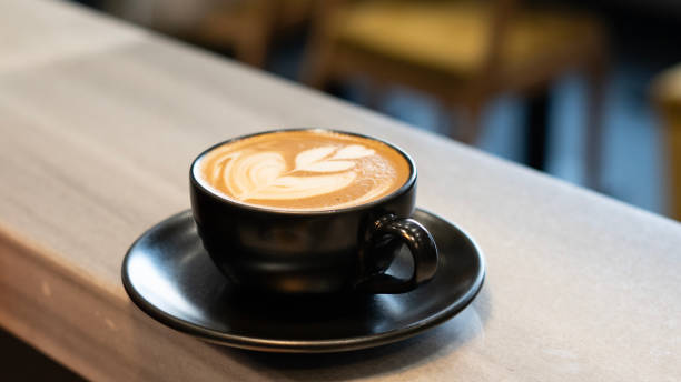 istock Latte cup stands on the cafe counter 1977154418