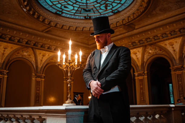 A handsome elegant 1920s style gentleman in a luxury stately home