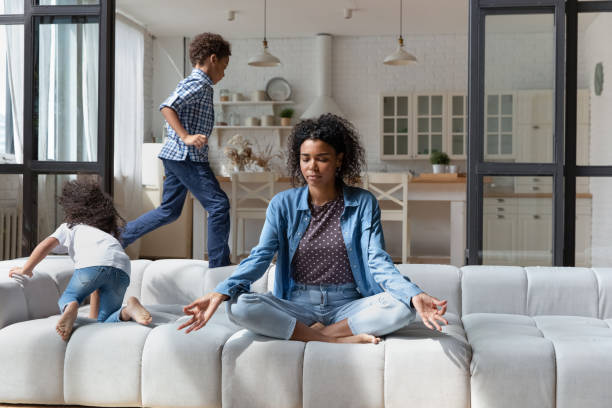 istock Calm African American mom meditating, keeping emotions under control 1977185568