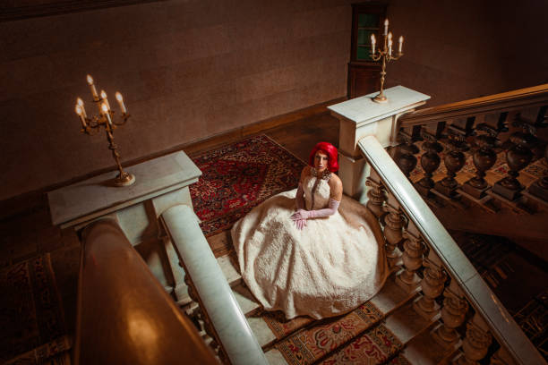 A beautiful elegant 1920s style redhead drag queen in a luxury stately home