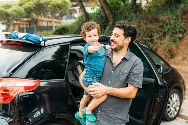 istock Happy father with little son standing near car 1977189307