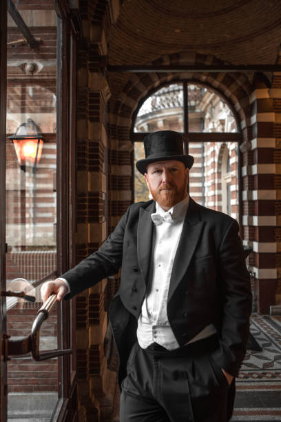 A handsome elegant 1920s style gentleman in a luxury stately home