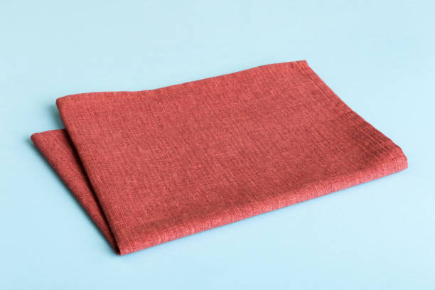 istock top view with red empty kitchen napkin isolated on table background. Folded cloth for mockup with copy space, Flat lay. Minimal style 1977193699