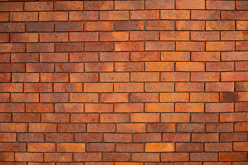 Red Textured Brick Wall Background with Old Cement Blocks and Brown Stone Pattern in Exterior Construction Architecture