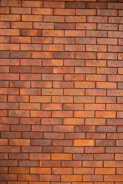 istock Red Textured Brick Wall Background with Old Cement Blocks and Brown Stone Pattern in Exterior Construction Architecture 1977195900