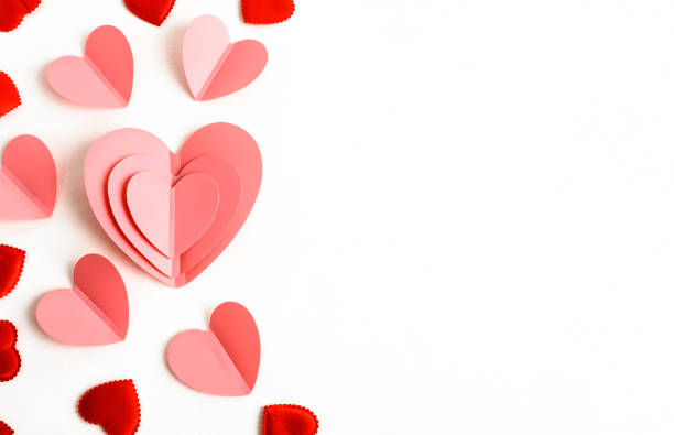 istock Background for Valentine's Day. Pink hearts and flowers on a light background. Flat layout and a place to copy 1977211863