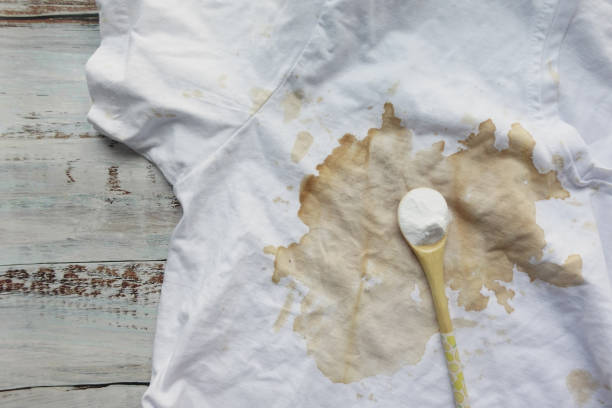 istock Organic removing sauce stain on clothes with baking soda , 1977220989