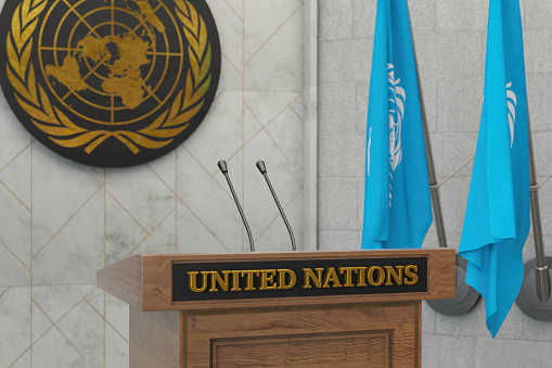 United Nations Summit Press Conference or Parliament Speech Concept with Flags. 3D Render