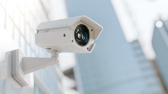 Security cameras under blue sky.