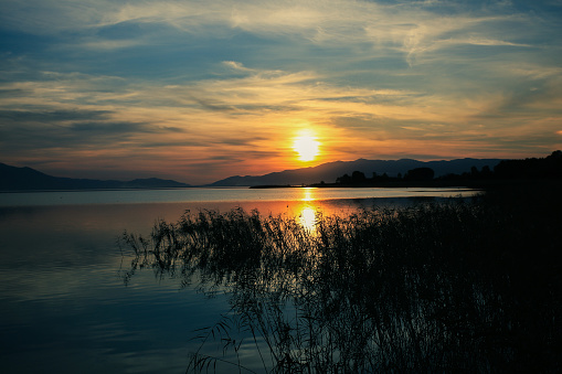 calm lake blue sky feather clouds sunset landscape
