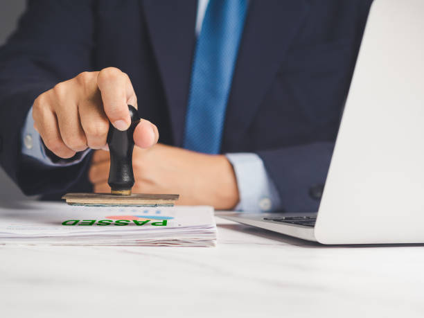 istock Businessman stamped for passed documents while sitting at a desk in the office. 1977263146