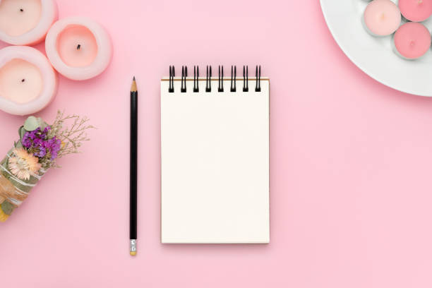 istock Blank notebook and pencil on pink background with pink candles and smudge stick 1977276695
