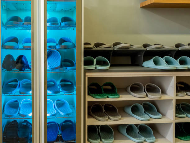 istock Household slippers inside a cabinet under ultra-violet (UV) light disinfection 1977280928