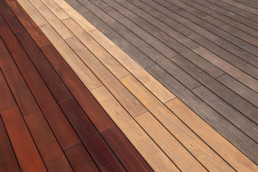 Wood deck diagonal planks- weathered, sanded, and freshly oiled, deck maintenance before and after