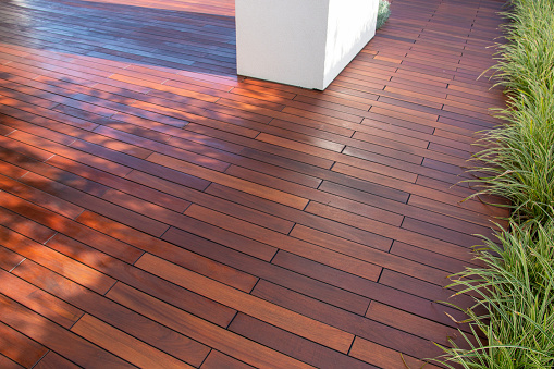 Ipe hardwood deck boards patio, idea with evergreen grass on side of exotic wood planks floor