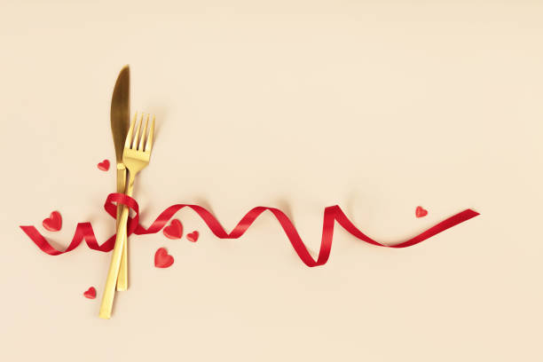 istock Fork and knife tied with a red ribbon. Romantic dinner. Valentine's Day 1977316837