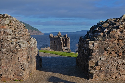 A view of the impressive ruins of Urquhart castle on the shore of Loch Ness in the Scottish Highlands.