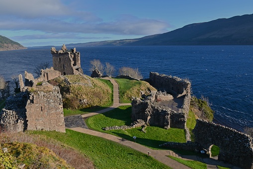 A view of the impressive ruins of Urquhart castle on the shore of Loch Ness in the Scottish Highlands.