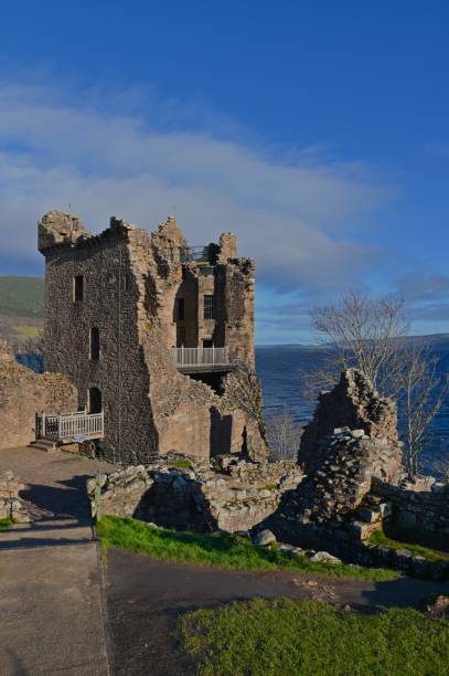 A view of the impressive ruins of Urquhart castle on the shore of Loch Ness in the Scottish Highlands.