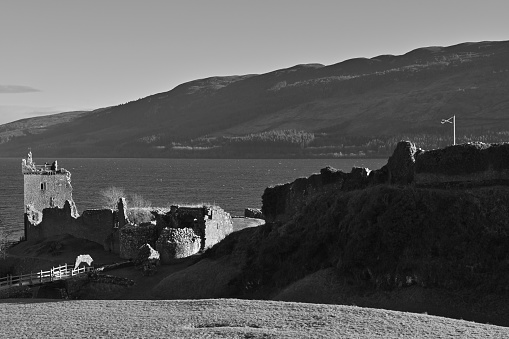 A view of the impressive ruins of Urquhart castle on the shore of Loch Ness in the Scottish Highlands.