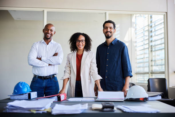 istock Smiling group of diverse architects standing together in an office 1977326690