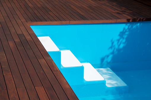 Swimming pool stairs and ipe decking edge, inground pool steps access into pool