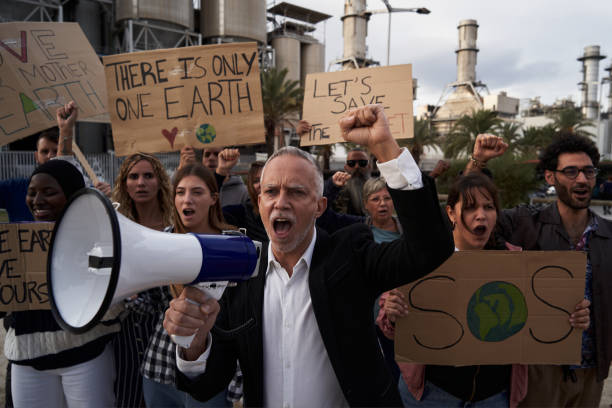 istock Mature man leading with megaphone a protest against pollution. 1977331564