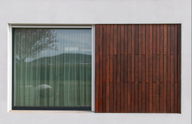 istock Large glass window next teak wood facade cladding, modern architecture concept 1977346026