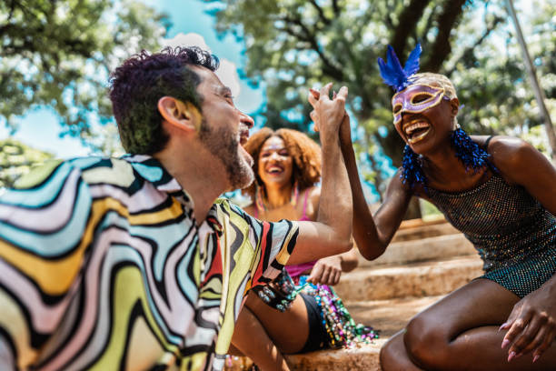 istock Friends enjoying carnival party in public park 1977351468