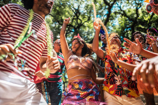 istock Friends enjoying carnival party on the public park 1977352006