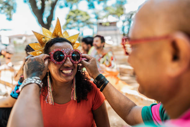 Friends preparing for carnival party outdoors