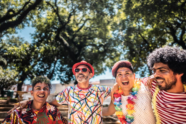 istock Friends celebrating carnival party on the public park 1977355233
