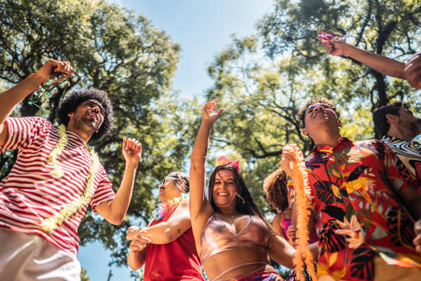 istock Friends celebrating carnival party on the public park 1977355749