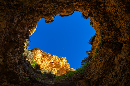 Clear sky from a hole in a cave  Alvor in Algarve, Portugal.