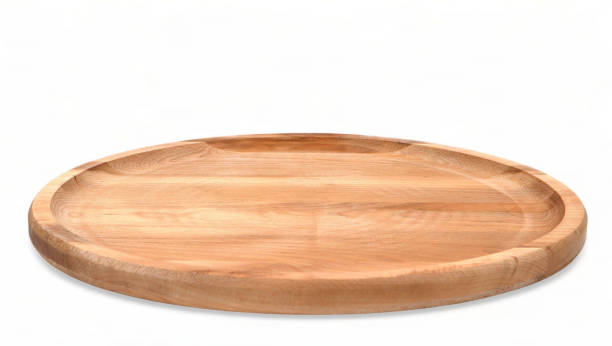 istock Empty round wooden plate with sides on a white background close-up. Space for branding, text or menu. Business food brand template. Layout. Cooking food. Culinary background. 1977376646