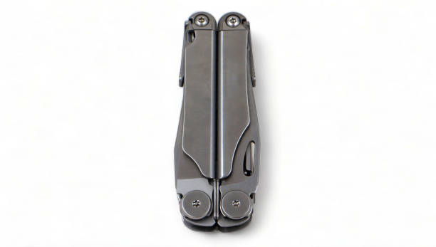 istock Folded steel multitool isolated on white background, top view. A tool for daily practice. All in one. Construction and repair. Compact and portable product. Pocket knife. EDC concept. 1977376671
