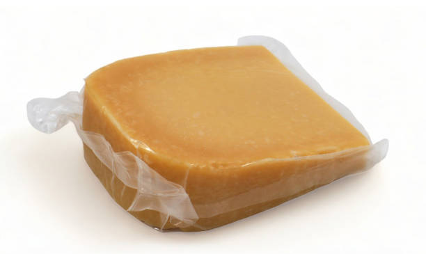 istock One parmesan cheese triangle in a transparent plastic wrap with soft shadows lies on a white background. Vacuum plastic bag with cheese. Mockup, packaging template with clipping path. 1977381025