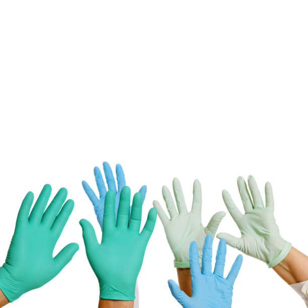istock Raised hands in surgical gloves isolated on white 1977386854