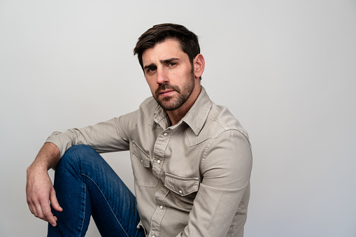 Adult male model posing with a serious expression against a plain background.