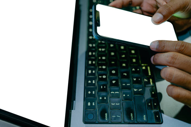 istock Cropped mockup laptop, white blank screen phone for hand typing test. 1977398189