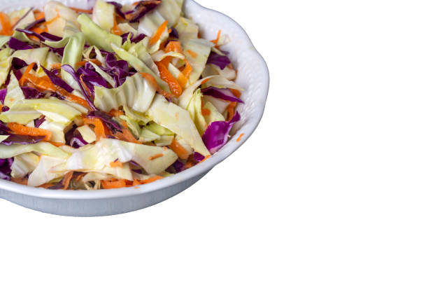 istock Fresh vegetables salad with purple cabbage, white cabbage, lettuce, carrot on white plate 1977405208