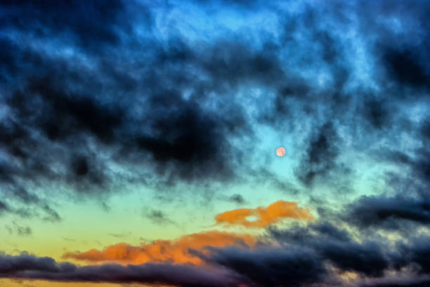 istock Moon in the sky with dark clouds 1977408418