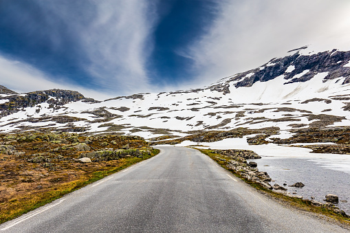 The mountains are covered with last year's snow. Summer trip to Norway. The road to Lake Djupvatnet. The road to the palace of the Snow Queen. Magical places in Norway.