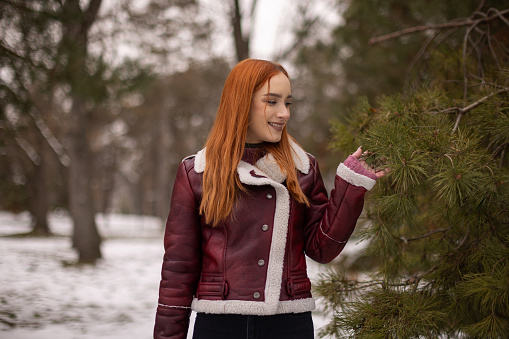 Young woman enjoying winter day in park