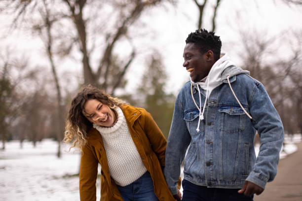 istock Young couple having fun time on a walk at public park 1977416471