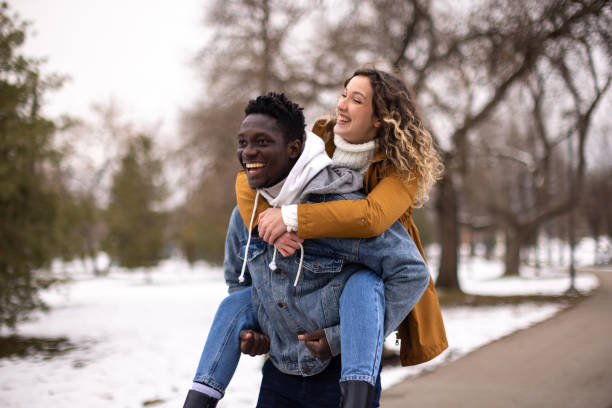 istock Happy couple in love having fun time at public park 1977417006