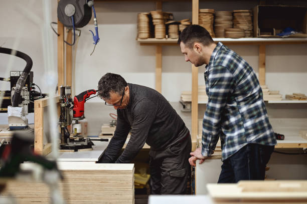 istock Two persons working as a woodworker and carpenter. 1977420205