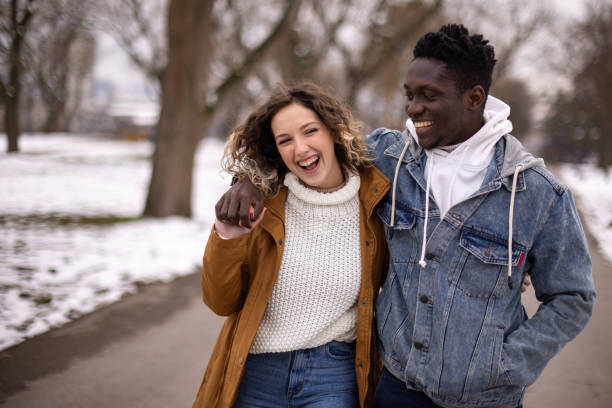 istock Young couple enjoying cold day in public park 1977422857