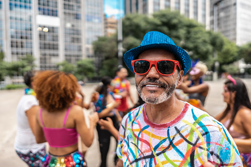 Portrait of a mature man having fun at a street carnival party
